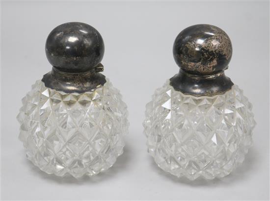 A pair of late Victorian silver topped cut glass scent bottles, by John Grinsell & Sons, London, 1893, 13.3cm.